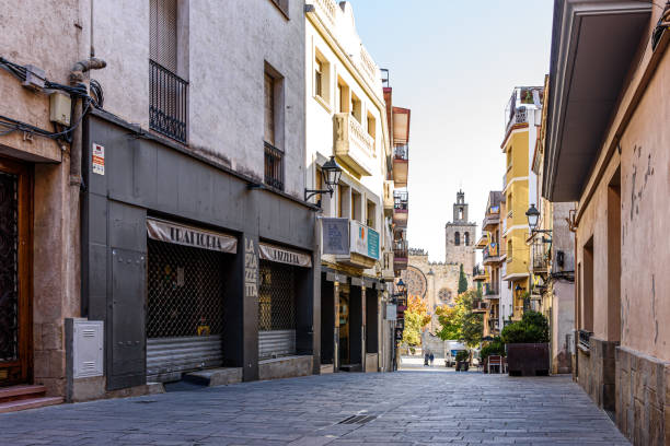 Sant Cugat del Valles- Catalonia, SPAIN - 10/23/2020: view of pedestrian street at city downtown with monastery on the background